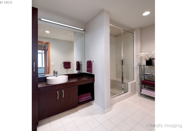 bathroom with tile patterned flooring, an enclosed shower, and vanity