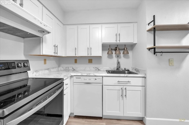 kitchen with white dishwasher, stainless steel range with electric stovetop, white cabinets, and light stone counters