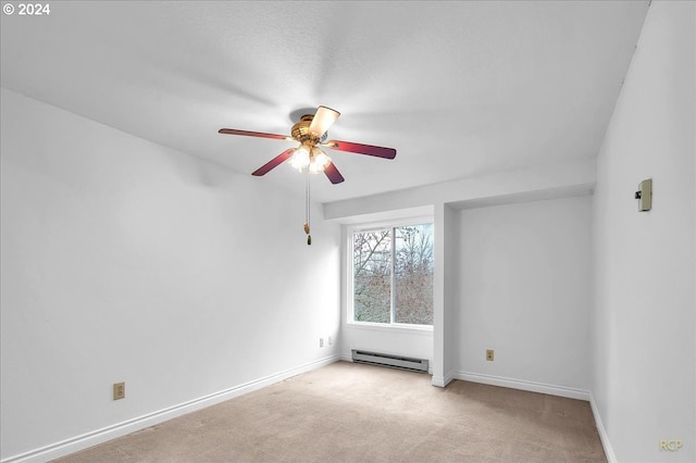 carpeted spare room featuring ceiling fan and baseboard heating