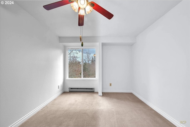 carpeted spare room featuring ceiling fan and a baseboard heating unit