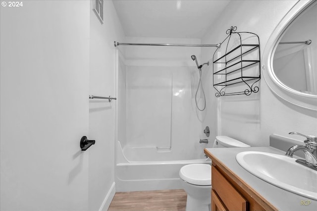 full bathroom featuring vanity, toilet, washtub / shower combination, and hardwood / wood-style flooring