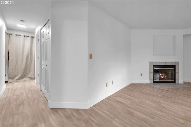 unfurnished living room featuring light hardwood / wood-style floors and a fireplace