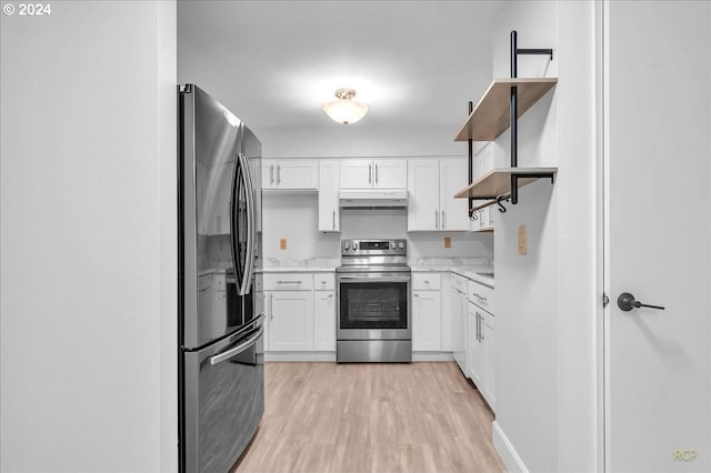 kitchen featuring white cabinets, light wood-type flooring, and appliances with stainless steel finishes