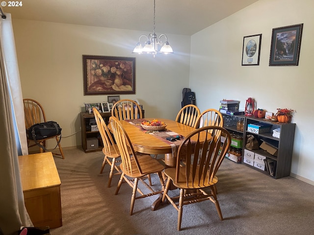 dining room with lofted ceiling, carpet flooring, and a chandelier