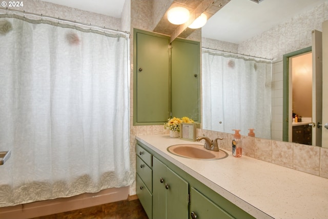 bathroom featuring shower / tub combo and vanity