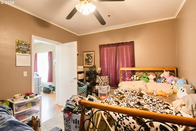 bedroom with light wood-type flooring, ceiling fan, and ornamental molding