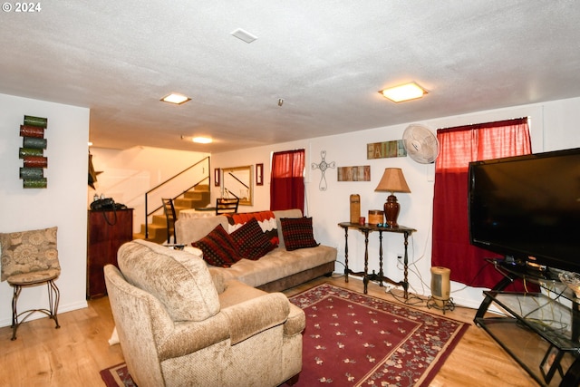 living room with hardwood / wood-style flooring and a textured ceiling