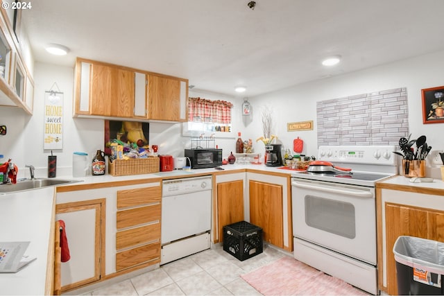 kitchen with white appliances, sink, and light tile patterned floors