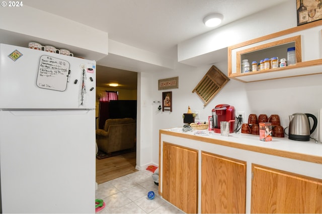 kitchen with white refrigerator and light tile patterned flooring