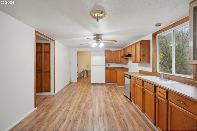 kitchen with dishwasher, sink, light hardwood / wood-style flooring, white refrigerator, and a textured ceiling