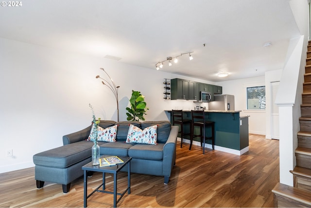 living room featuring dark wood-type flooring and track lighting