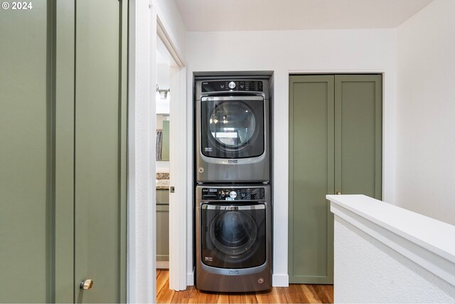 washroom featuring stacked washer / dryer and light wood-type flooring