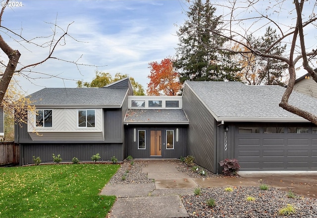 view of front of home with a garage and a front lawn