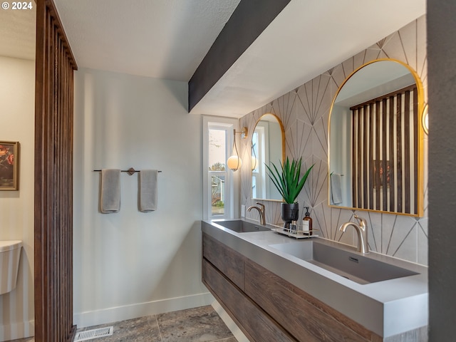 bathroom with decorative backsplash and vanity