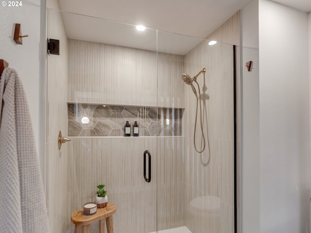 bathroom featuring a shower with shower door