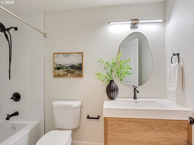 full bathroom featuring toilet, tiled shower / bath combo, and vanity