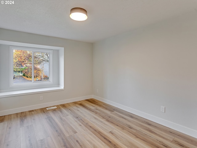 unfurnished room featuring light hardwood / wood-style floors