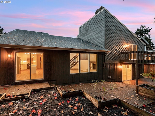 view of back house at dusk