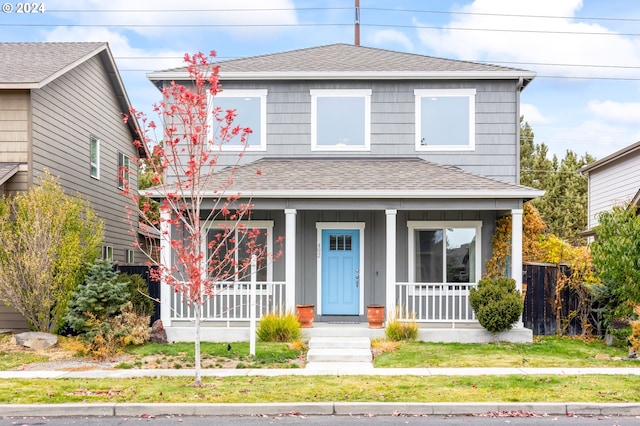 view of front of house featuring a front yard and a porch