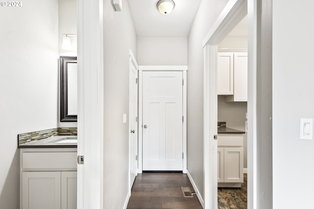 hallway with dark wood-type flooring