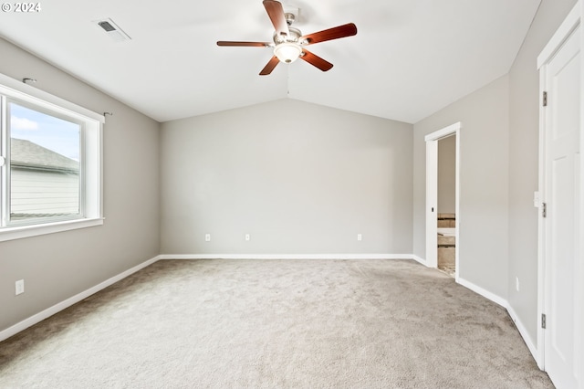 carpeted empty room featuring lofted ceiling and ceiling fan