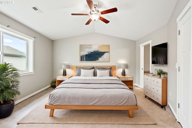 bedroom with vaulted ceiling, light wood-type flooring, and ceiling fan