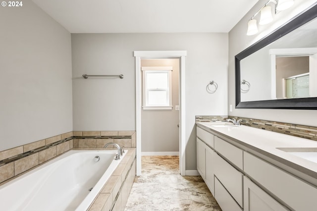 bathroom with vanity and tiled bath