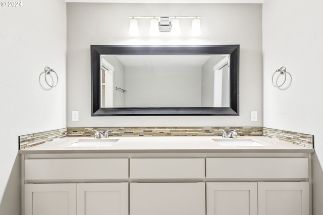 bathroom with vanity and decorative backsplash