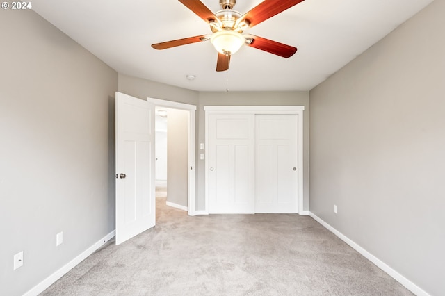 unfurnished bedroom with a closet, ceiling fan, and light carpet