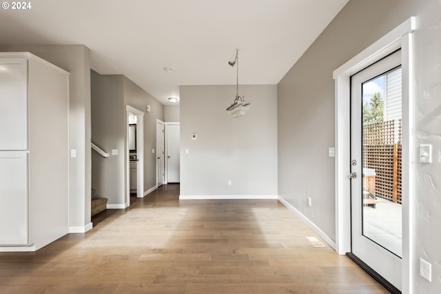 unfurnished dining area with light wood-type flooring