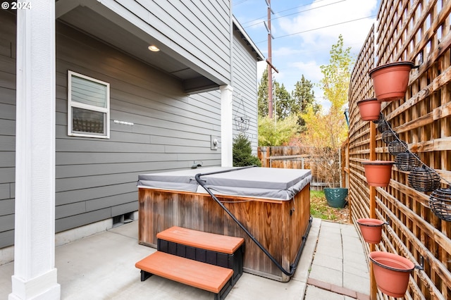 view of patio / terrace with a hot tub