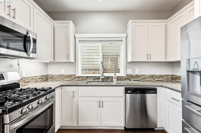 kitchen featuring sink, white cabinets, stainless steel appliances, and tasteful backsplash