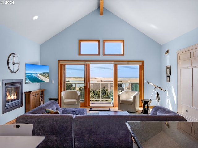 living room with beam ceiling and high vaulted ceiling