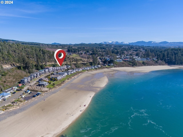 bird's eye view with a water and mountain view and a view of the beach