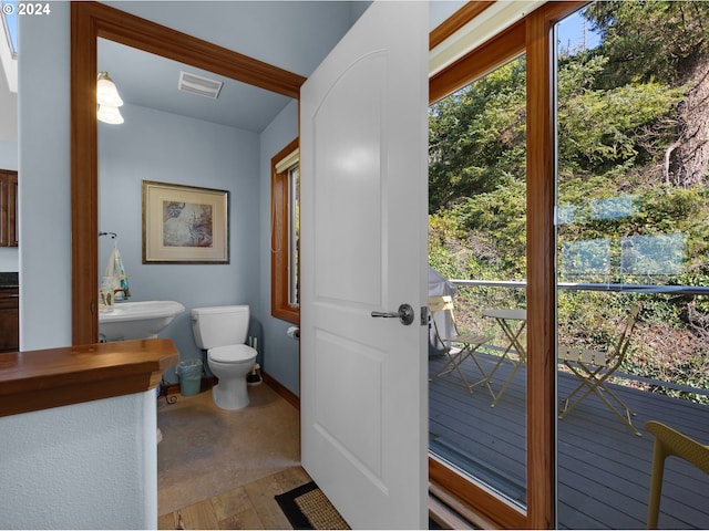 bathroom featuring hardwood / wood-style flooring, toilet, and sink