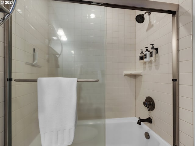 bathroom featuring bath / shower combo with glass door