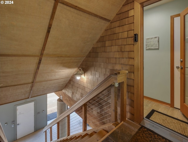 interior space with light wood-type flooring and lofted ceiling