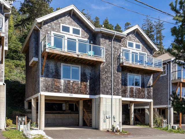 view of front of home featuring a balcony and a carport