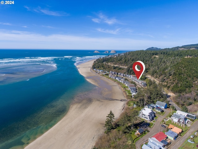 bird's eye view with a water view and a beach view