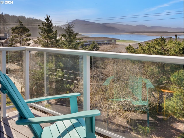 balcony with a water and mountain view