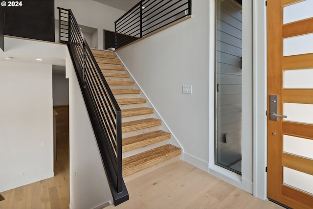 stairs with hardwood / wood-style floors