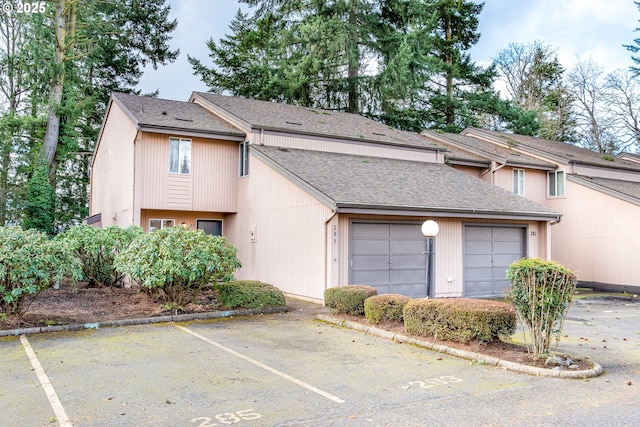 view of home's exterior featuring uncovered parking and roof with shingles