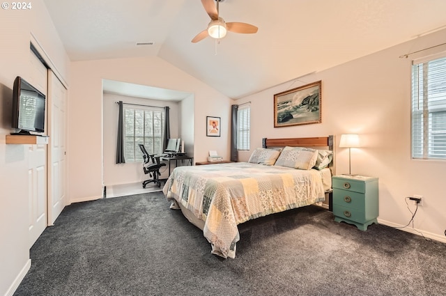 carpeted bedroom with ceiling fan, a closet, and lofted ceiling