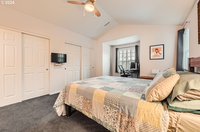 carpeted bedroom featuring lofted ceiling, ceiling fan, and multiple closets