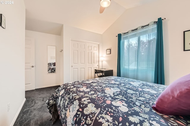 bedroom featuring ceiling fan, dark carpet, lofted ceiling, and a closet