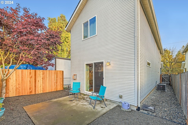 rear view of property with a patio and central AC unit