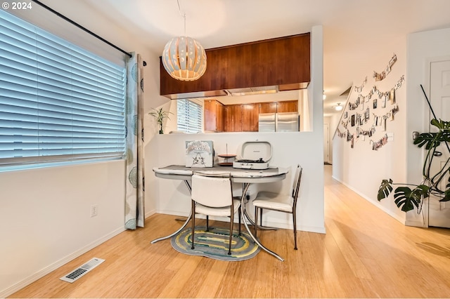 dining space featuring light wood-type flooring