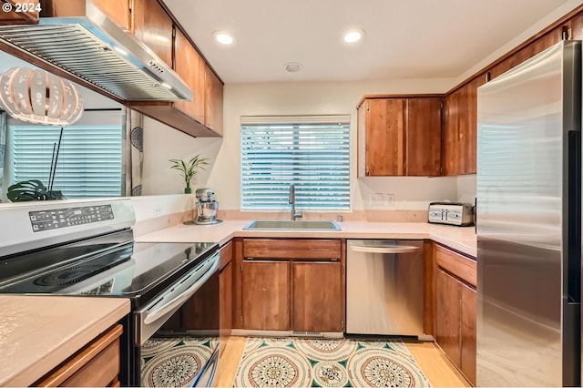 kitchen featuring sink, extractor fan, and appliances with stainless steel finishes