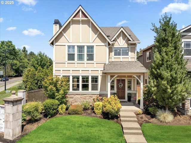 tudor-style house with a front lawn