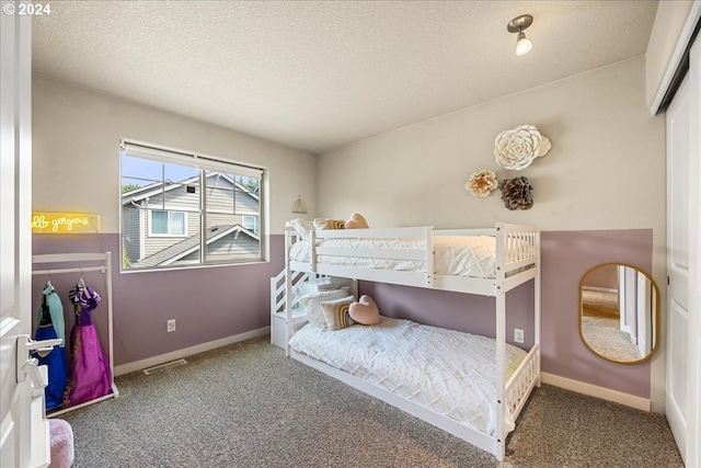 bedroom with carpet floors and a textured ceiling